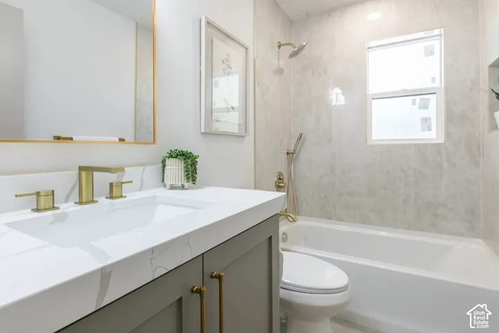 Built-in vanity with a rectangular undermount sink, brass-finish faucet, and white countertop