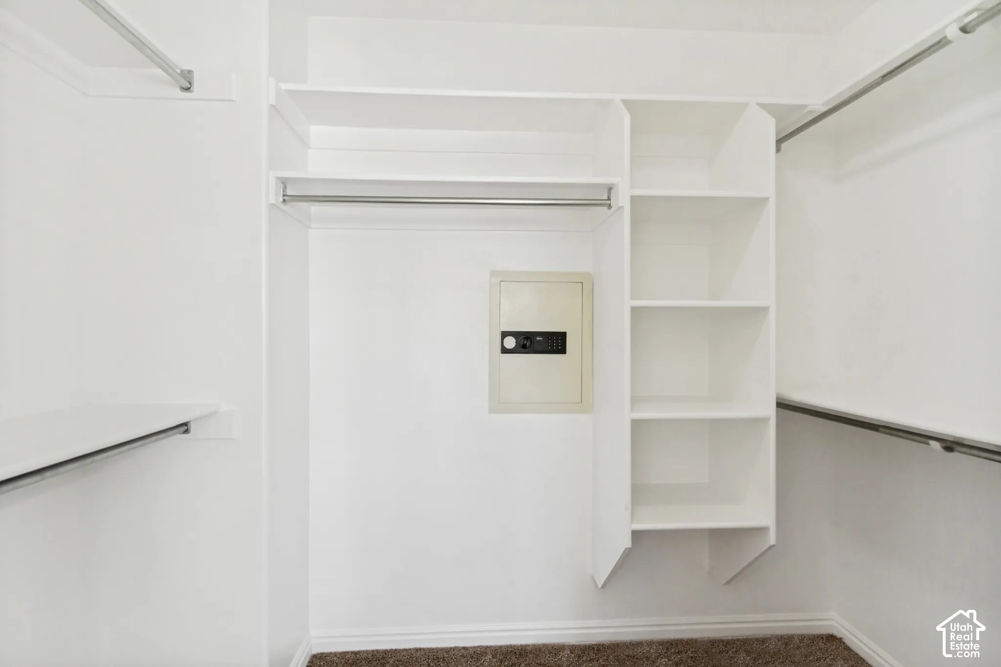 White-painted closet system featuring multiple hanging rods and built-in shelving