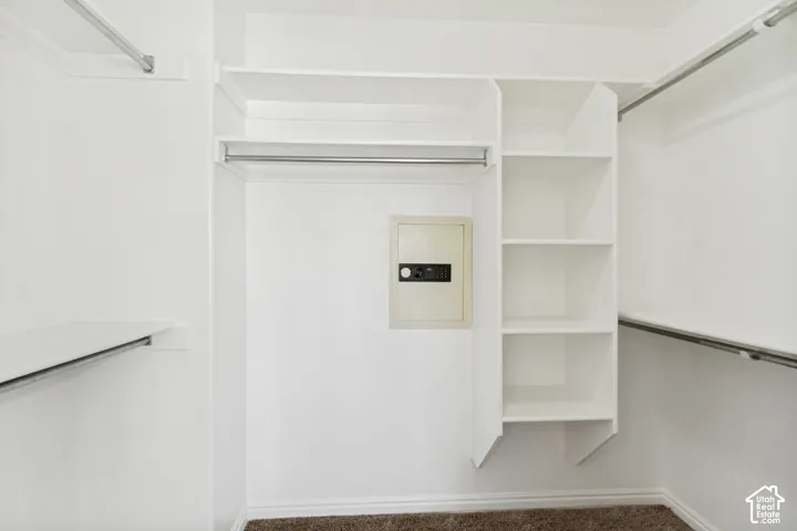 White-painted closet system featuring multiple hanging rods and built-in shelving