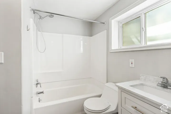 Bathroom featuring a white bathtub and shower combination with chrome fixtures