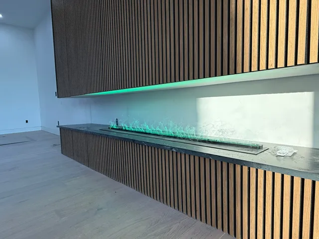 Vertical wood-finish paneling with integrated linear lighting