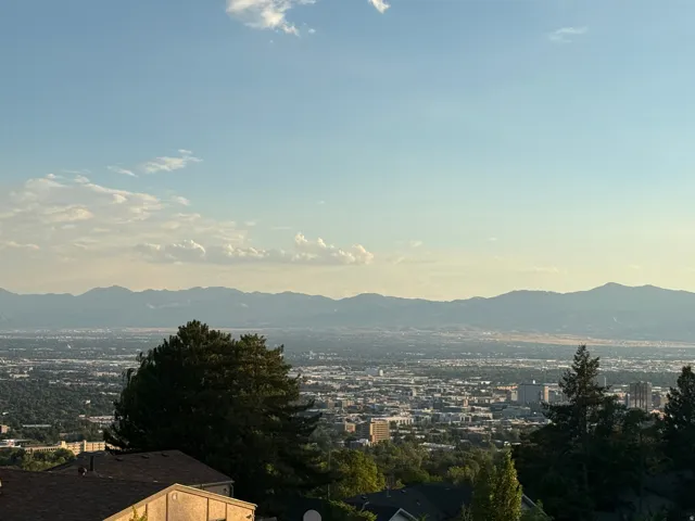Expansive city and mountain scenery, featuring distant structures and a clear sky