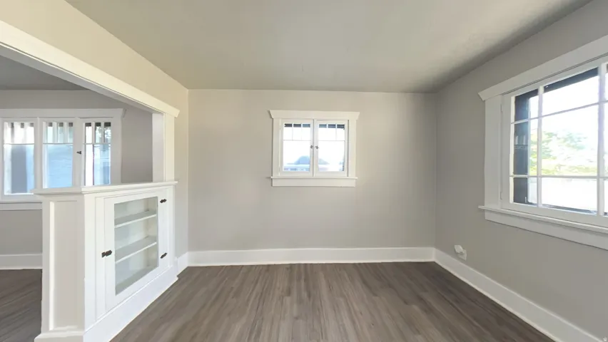 Room featuring wood-finish flooring and light gray painted walls