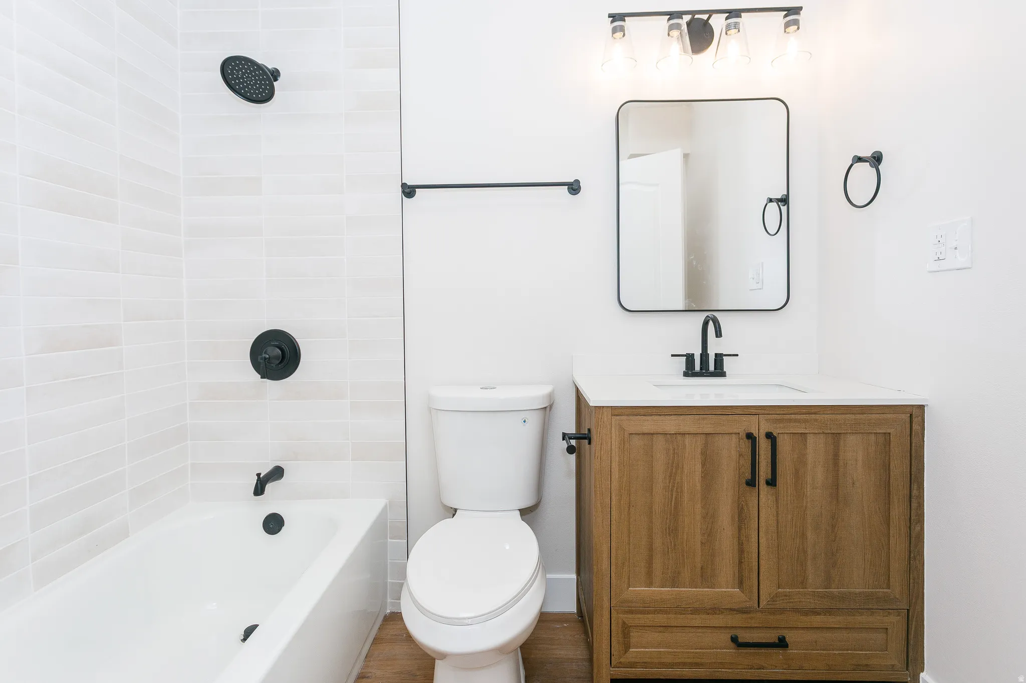 Bathroom featuring a wood-finish vanity with a white countertop and rectangular undermount sink