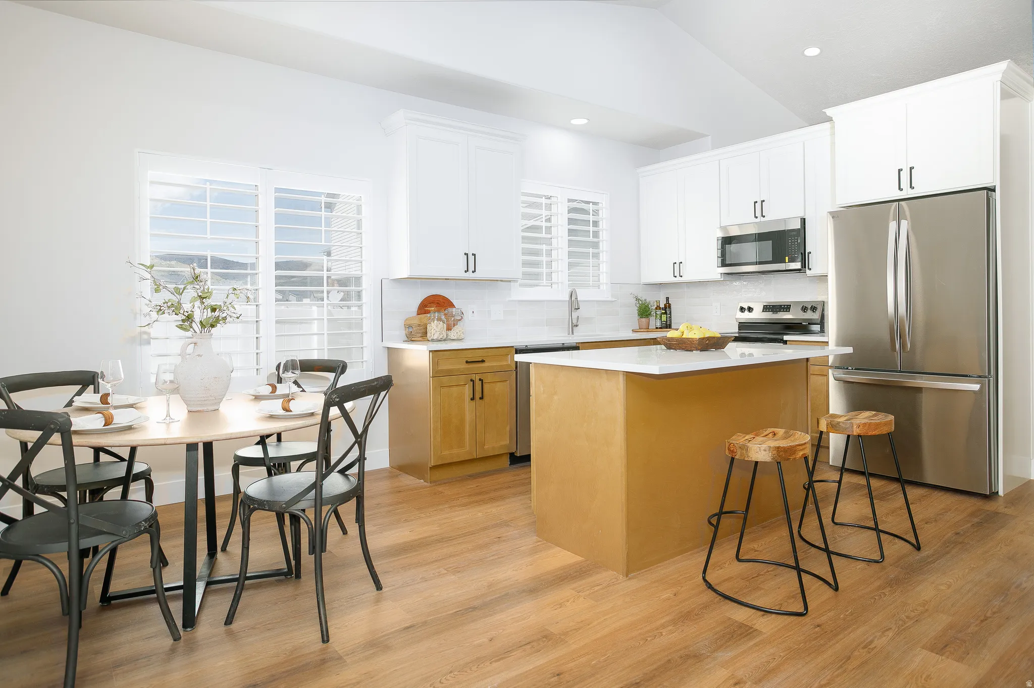 Open-concept kitchen and dining area featuring a central island with countertop seating