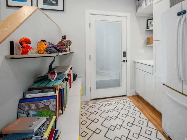 Entryway featuring a white paneled door with frosted glass, wood-finish flooring, built-in shelving, white cabinetry, and recessed lighting