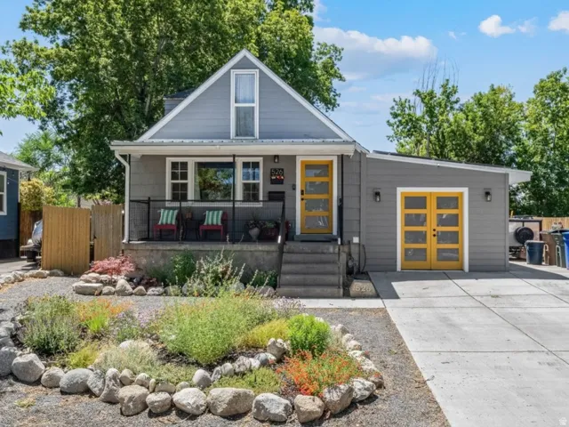 Charming gray home with a gabled roofline and a front porch