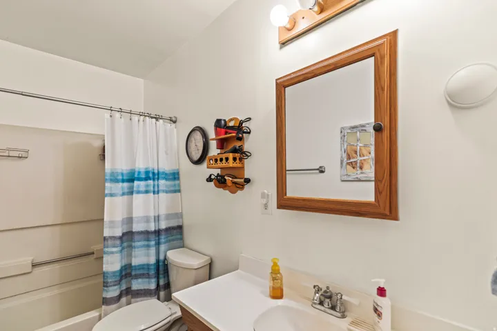 Bathroom featuring a white bathtub, toilet, and vanity with a white countertop