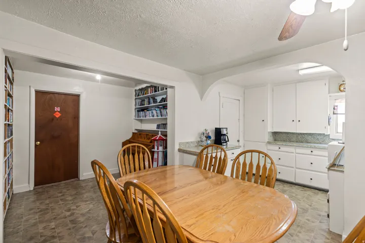 Dining area featuring wood-finish flooring and a ceiling fan