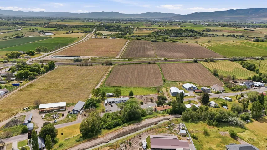 Expansive rural landscape featuring agricultural fields and distant mountains
