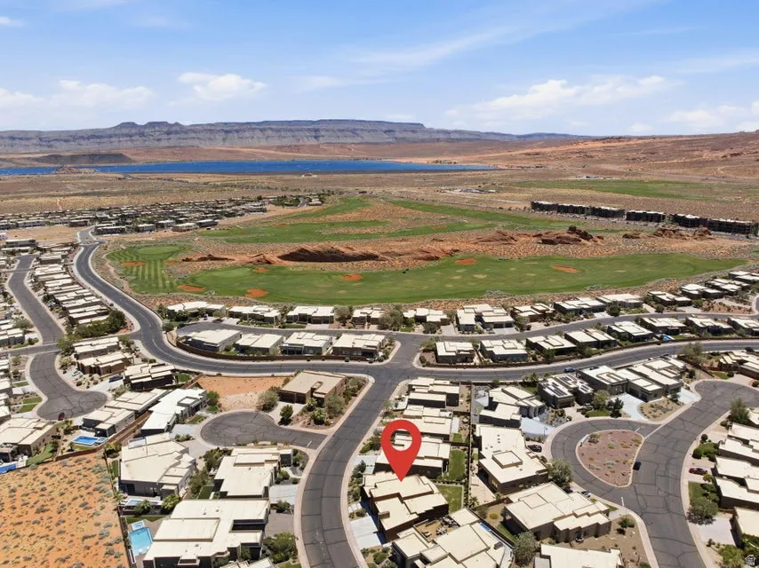 Aerial perspective showcasing a residential community with desert landscaping and paved roadways
