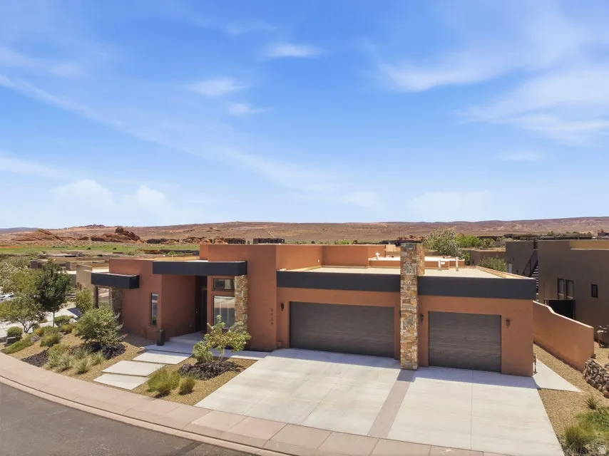 Modern desert-style residence with a flat roofline and integrated two-car garage