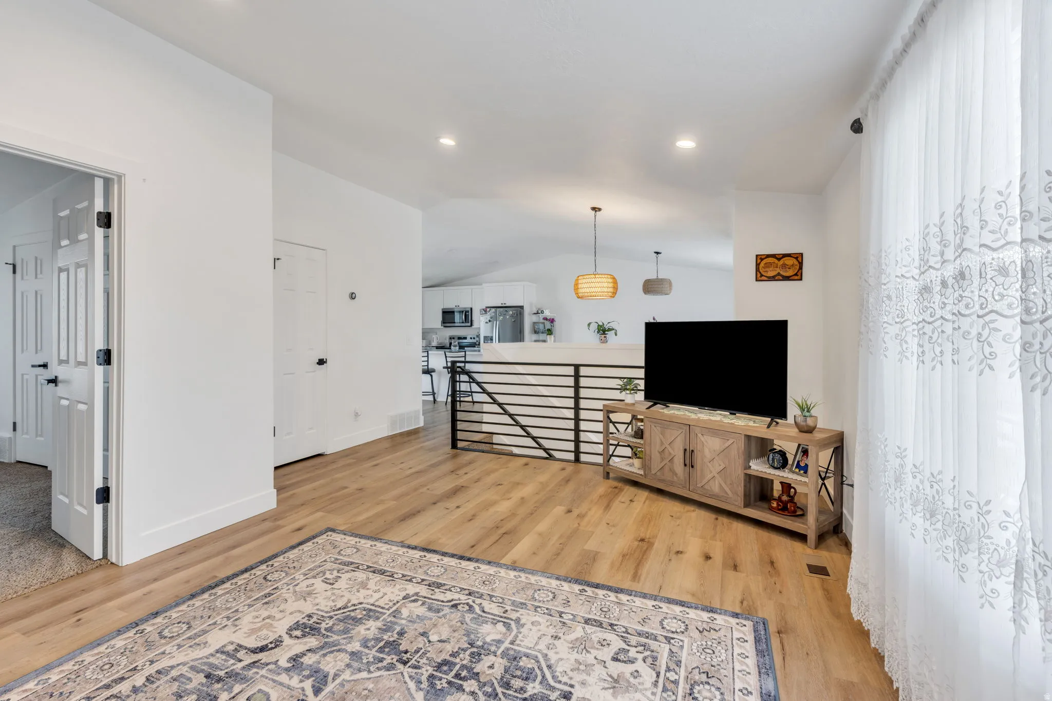 Bright interior space featuring wood-finish flooring, recessed lighting, and white walls