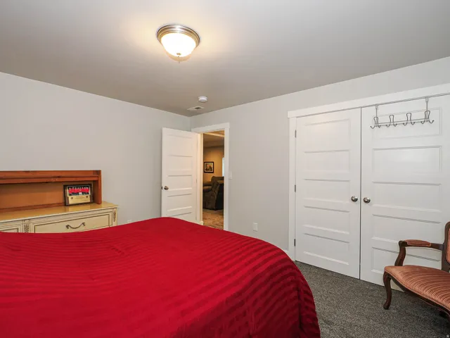 Neutral wall color, paneled interior doors, and overhead flush-mount lighting