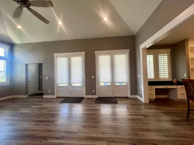 Vaulted ceiling featuring a ceiling fan and recessed lighting, wood-finish flooring, and white plantation shutters