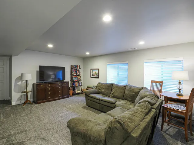 Recessed ceiling lighting, light gray wall paint, and gray carpeting