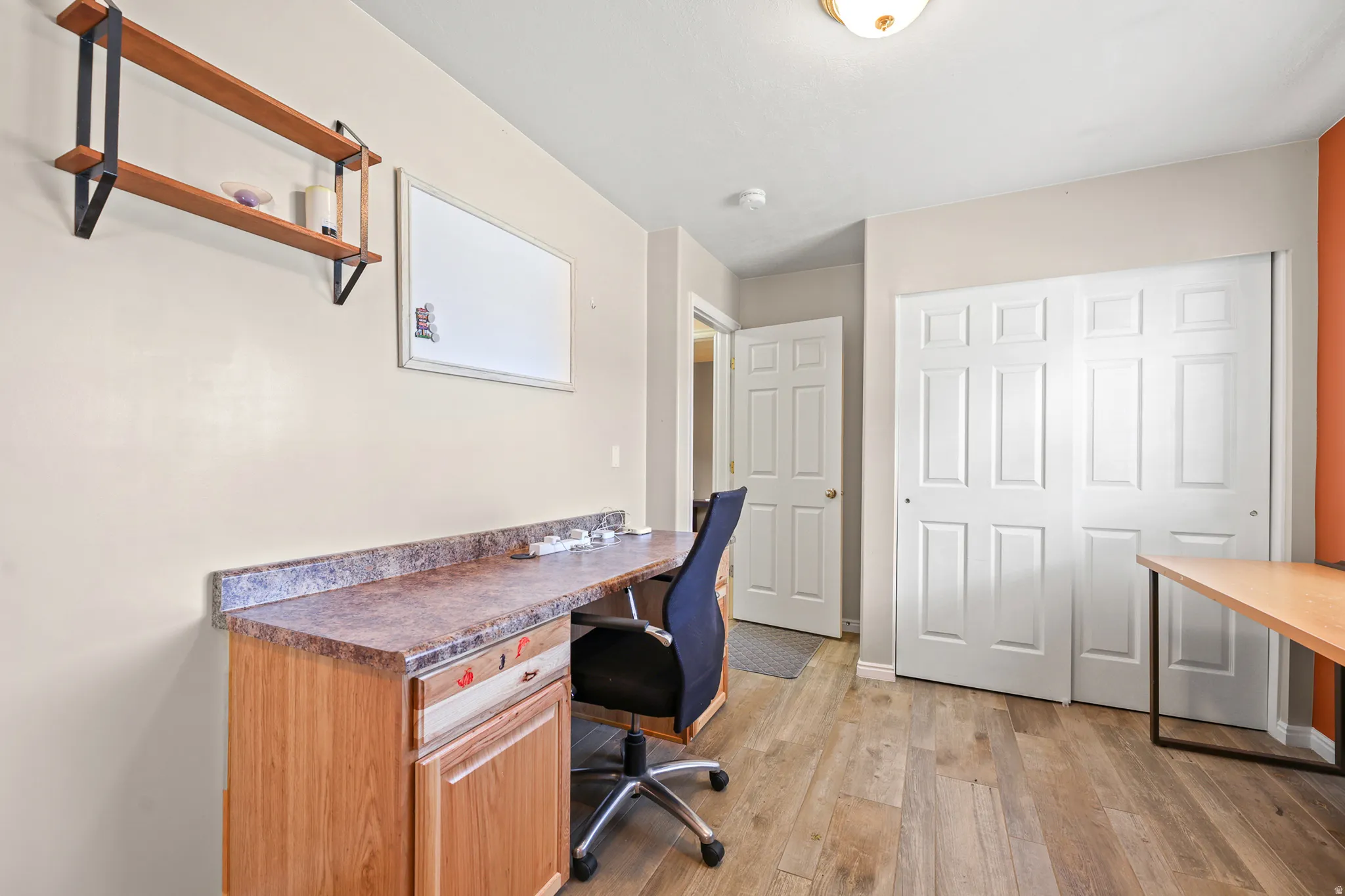 large office with built in desk and cabinets
