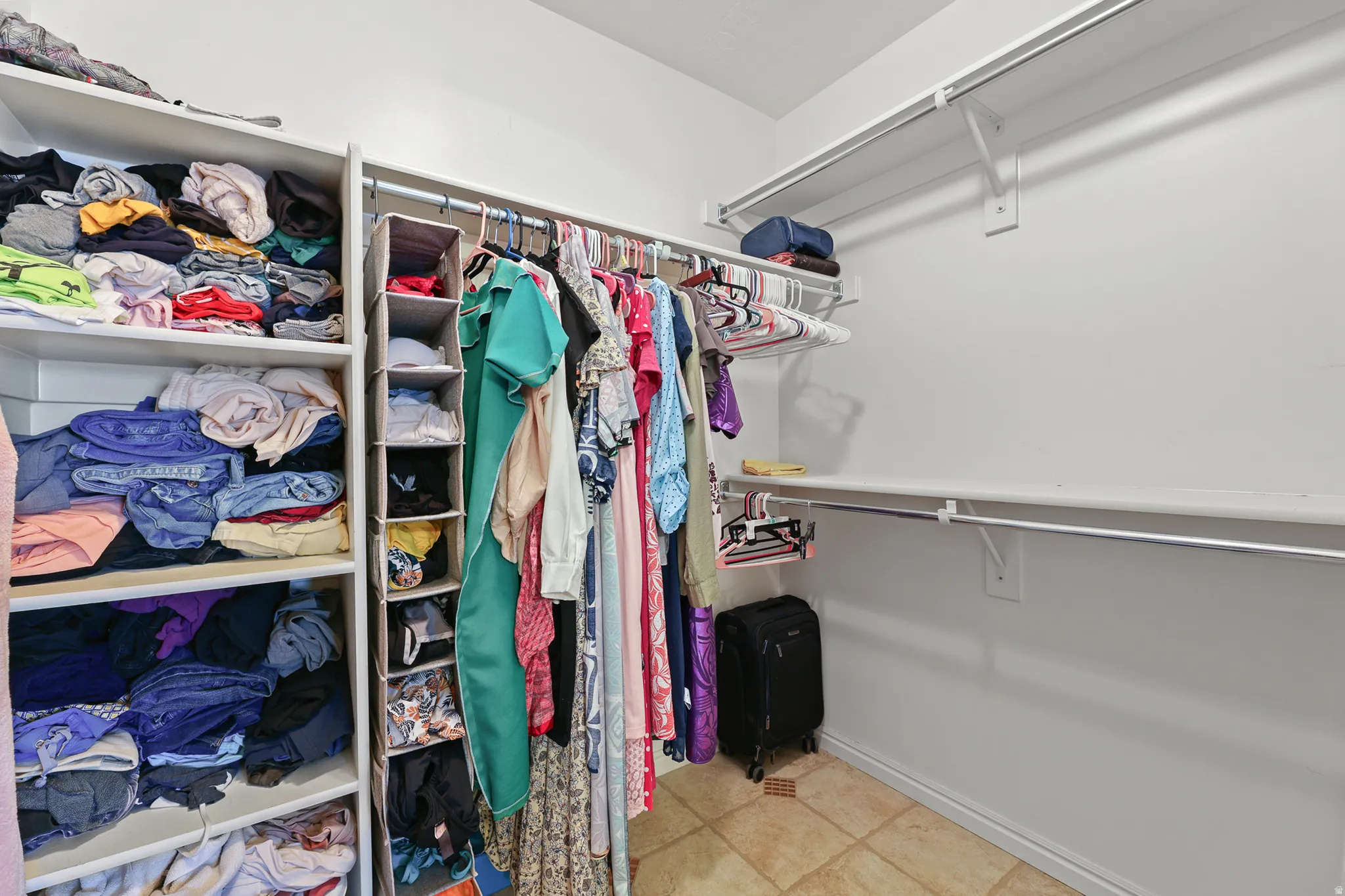 Enjoy a spa-like primary bathroom featuring his-and-her vanities, a separate walk-in shower, a jetted tub, and an oversized walk-in closet.