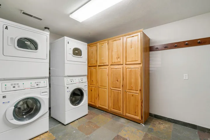 Spacious utility area featuring two stacked washer and dryer units