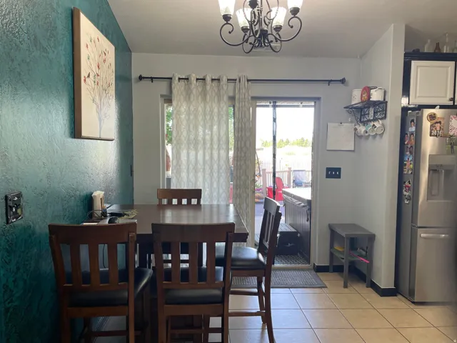 Dining area with tile flooring and direct patio access via sliding glass doors