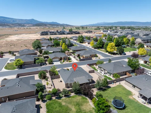 Aerial perspective showcasing a residential neighborhood with distant mountain ranges