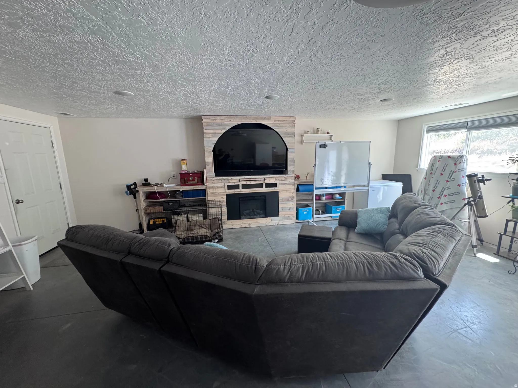 Entertainment space featuring a shiplap-style media wall with an integrated electric fireplace
