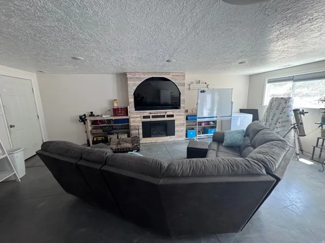Entertainment space featuring a shiplap-style media wall with an integrated electric fireplace