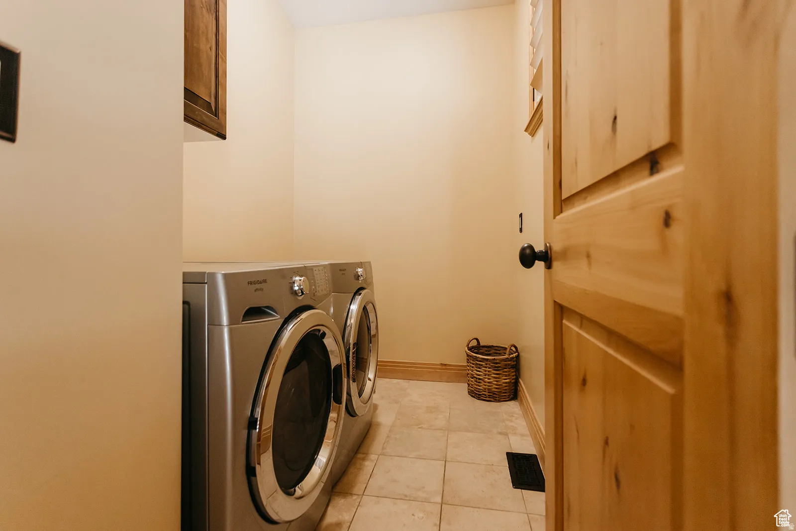 Dedicated laundry area featuring a front-loading washer and dryer set