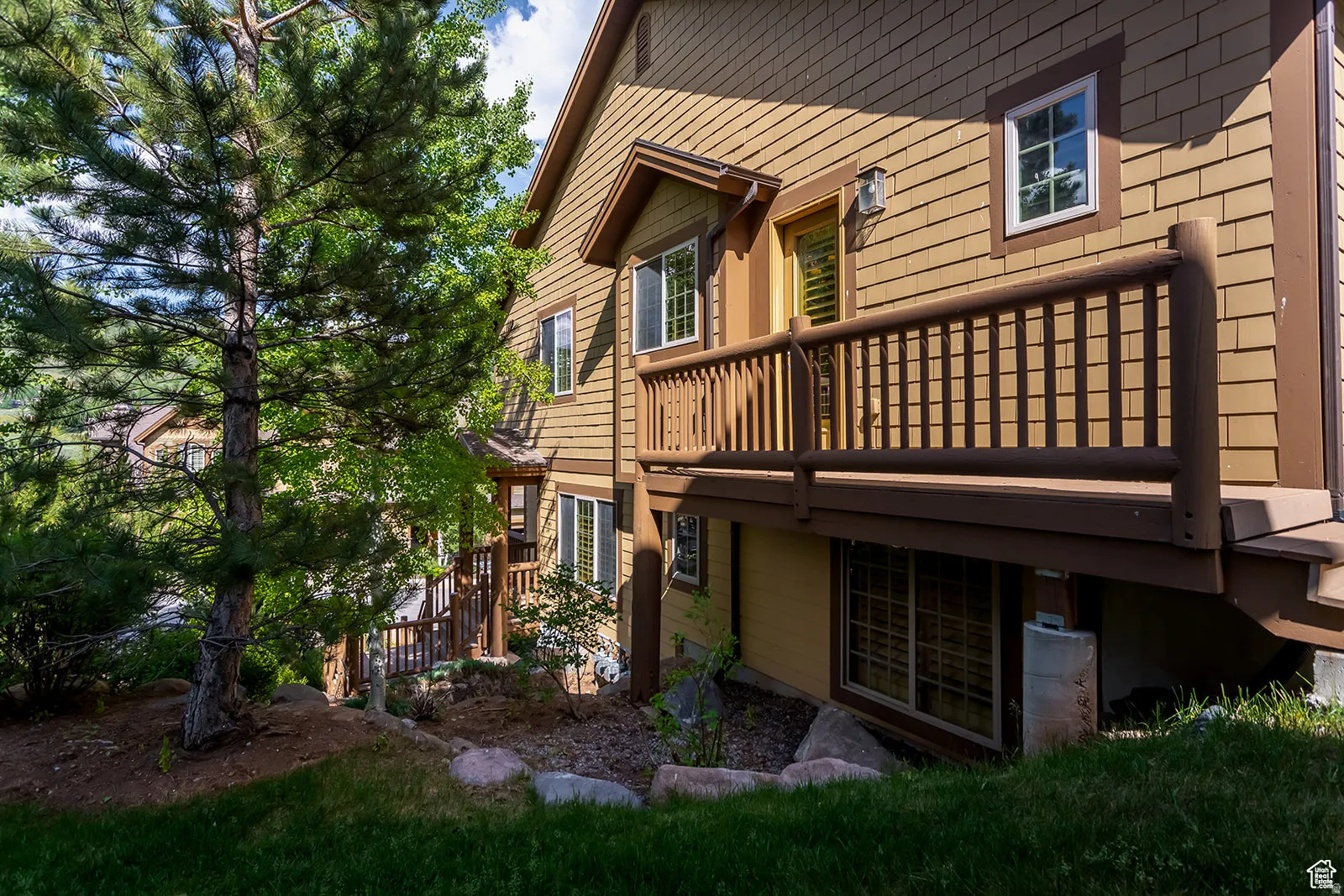 Multi-level exterior with shingle siding and contrasting trim