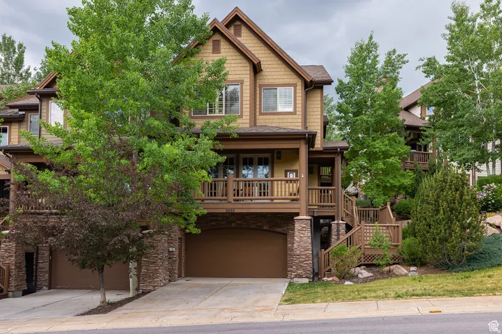 Two-story residence featuring a ground-level two-car garage and a second-level balcony