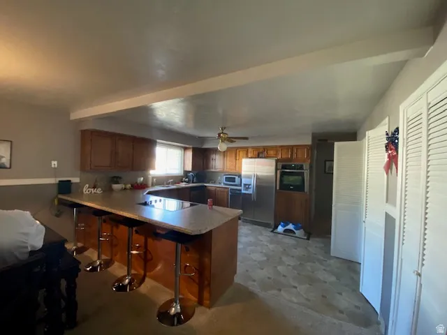 Kitchen featuring wood cabinetry, stainless steel appliances, and a built-in oven
