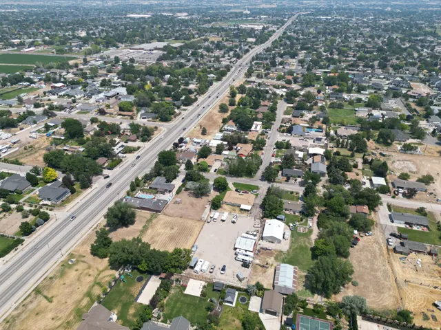 Aerial perspective showcasing a residential area with extensive tree coverage
