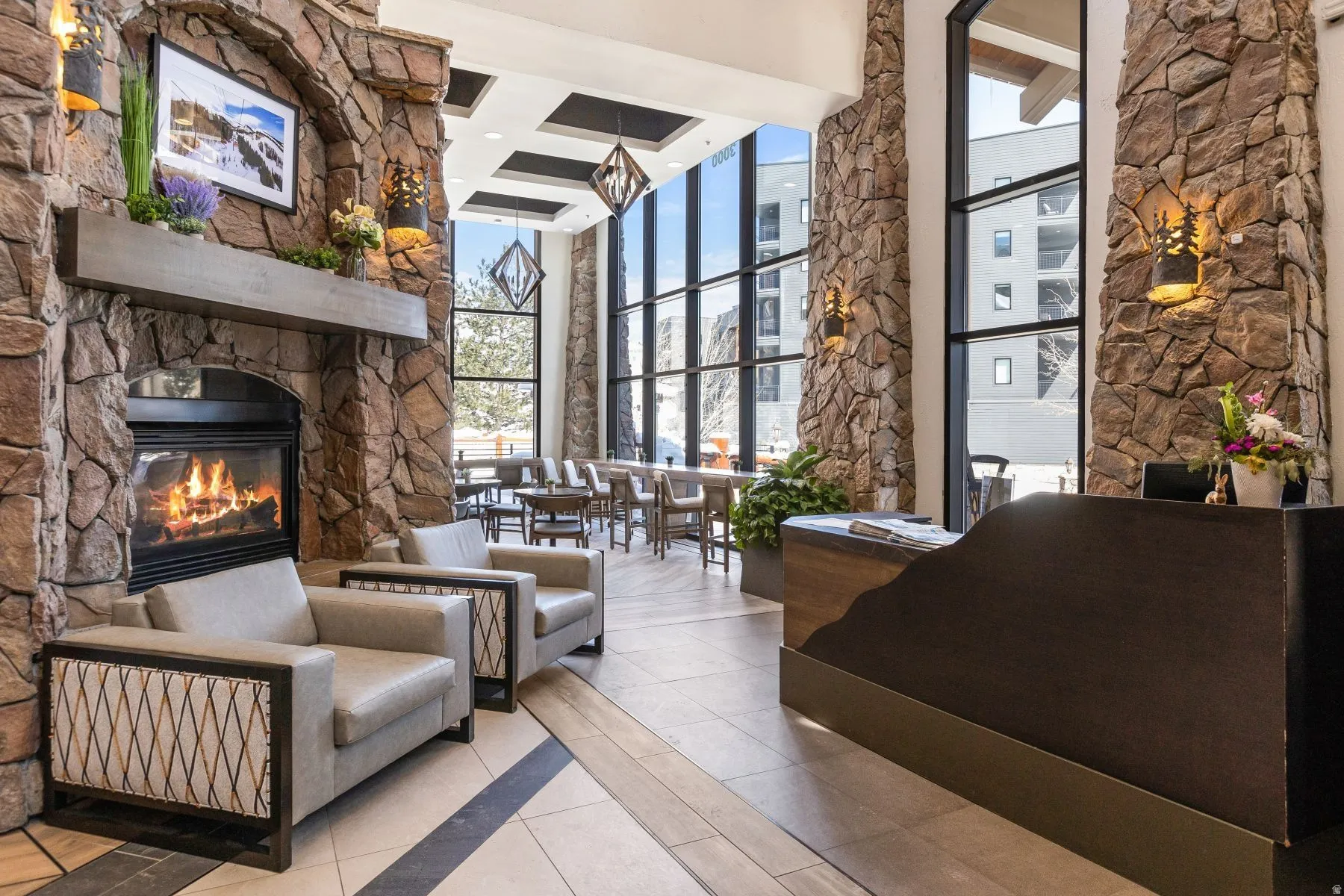 Stone-clad fireplace with a substantial hearth and mantel, complemented by two neutral armchairs