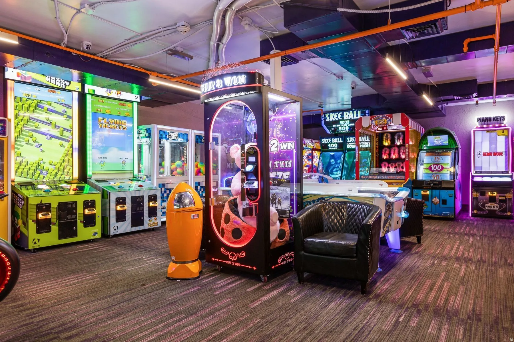 Entertainment space featuring carpet flooring and multiple arcade machines