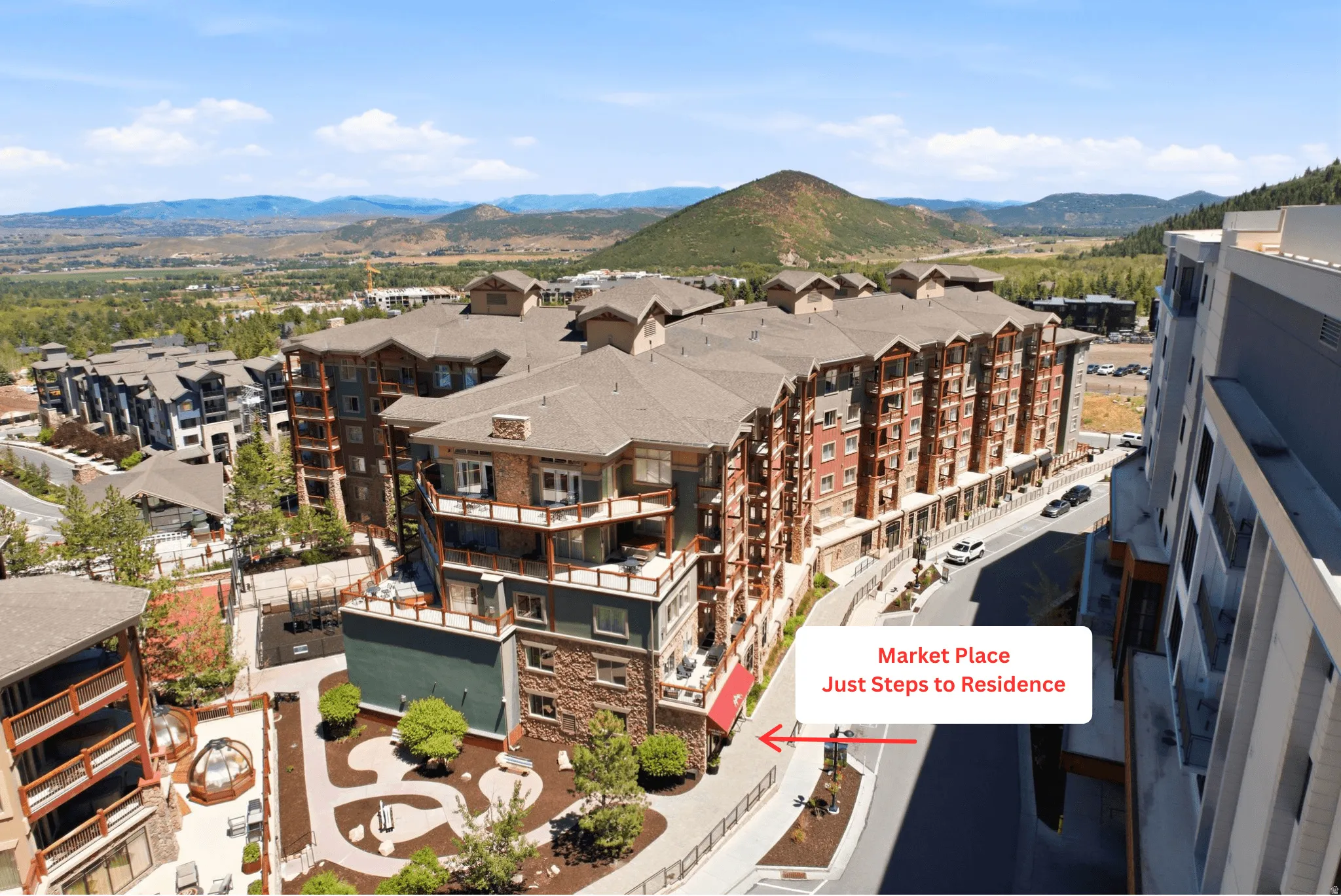 Expansive multi-story residential complex with balconies and a stone and brick facade