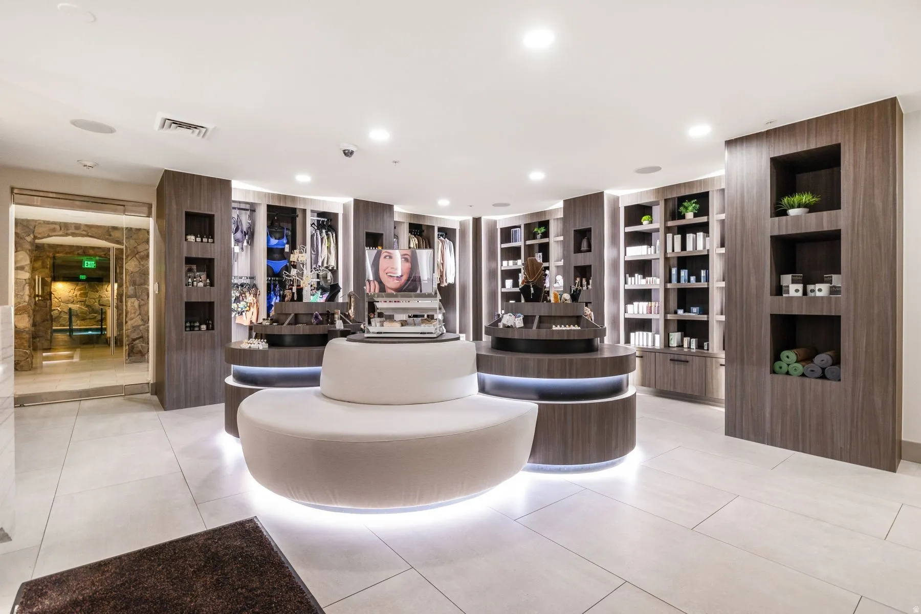 Contemporary retail space featuring integrated wood-finish display shelving and built-in cabinetry