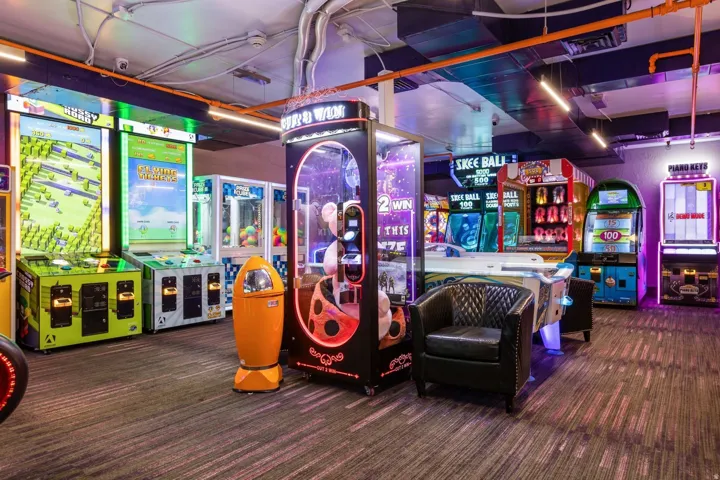 Entertainment space featuring carpet flooring and multiple arcade machines