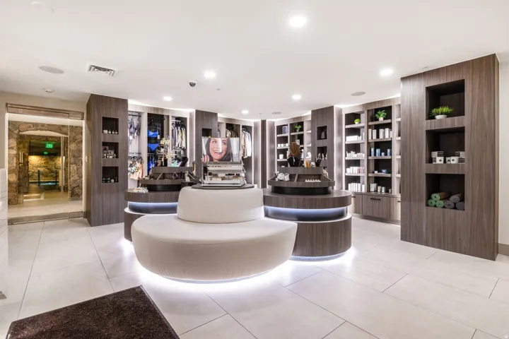 Contemporary retail space featuring integrated wood-finish display shelving and built-in cabinetry
