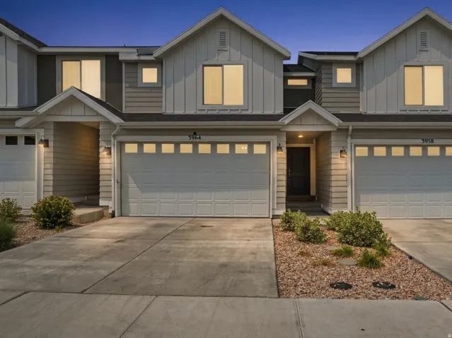 Modern townhome exterior featuring board and batten siding, horizontal siding, and multiple gables