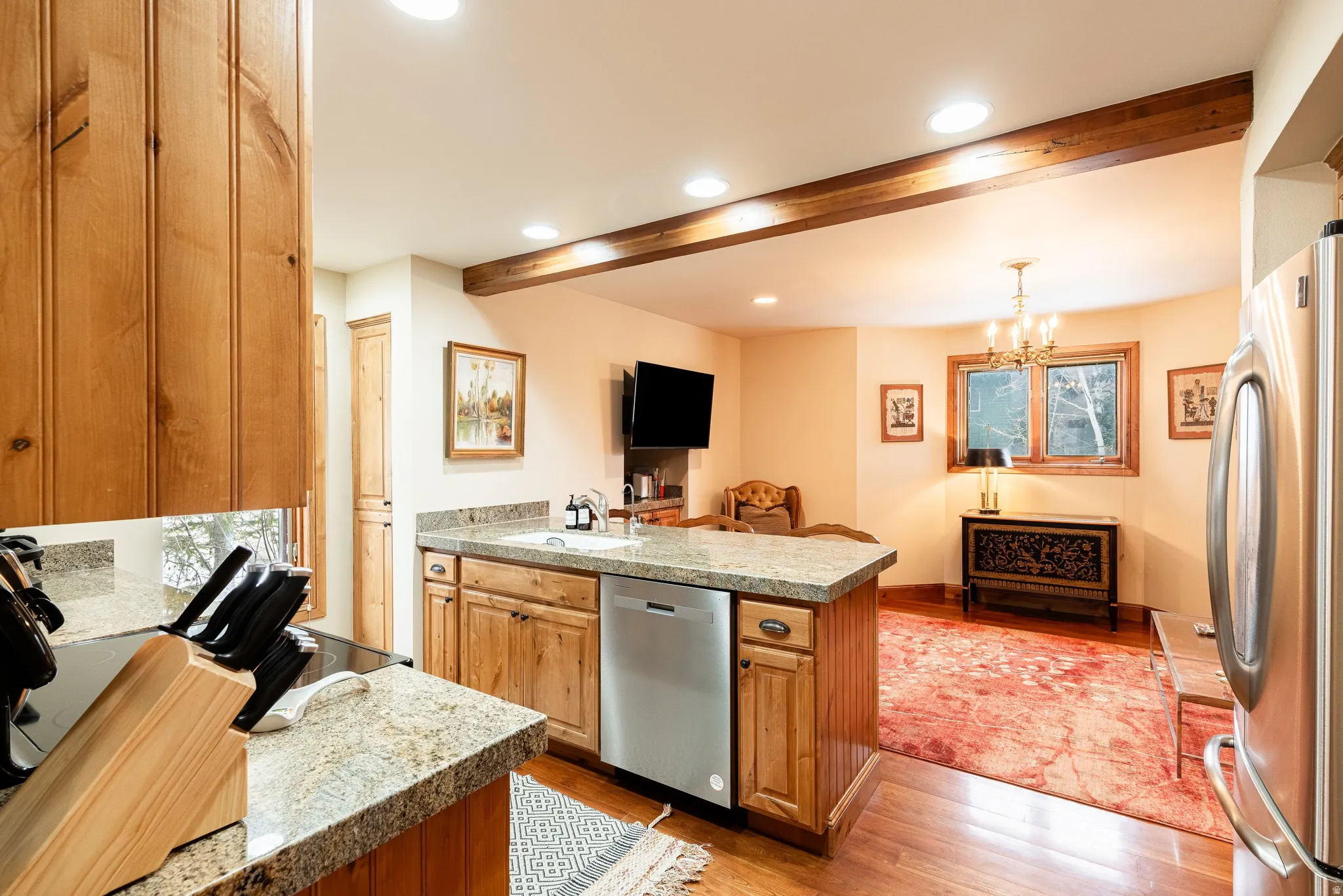 Kitchen featuring wood-finish cabinetry, granite-style countertops, and stainless steel appliances