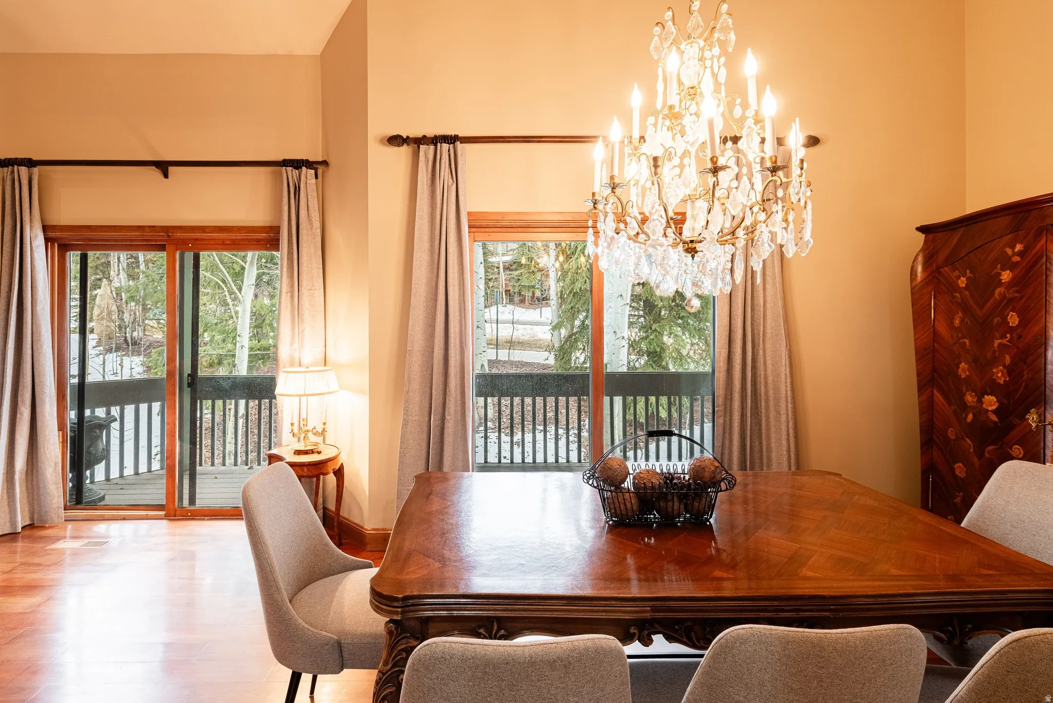 Formal dining area with wood-finish flooring and a decorative chandelier