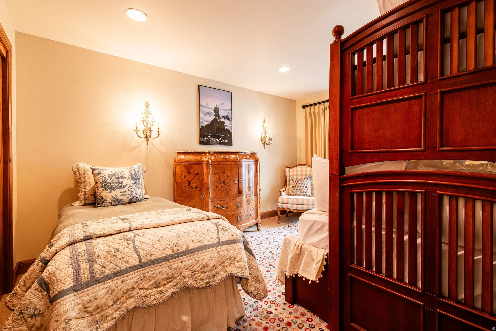 Interior space with recessed lighting and two ornate wall sconces