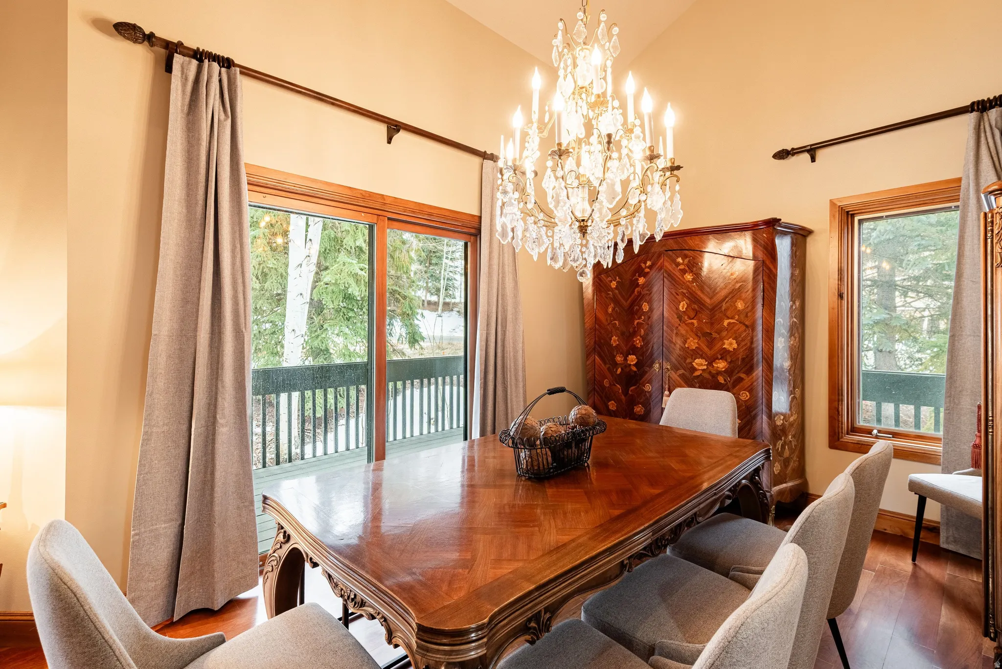 Formal dining space featuring a vaulted ceiling and a crystal chandelier