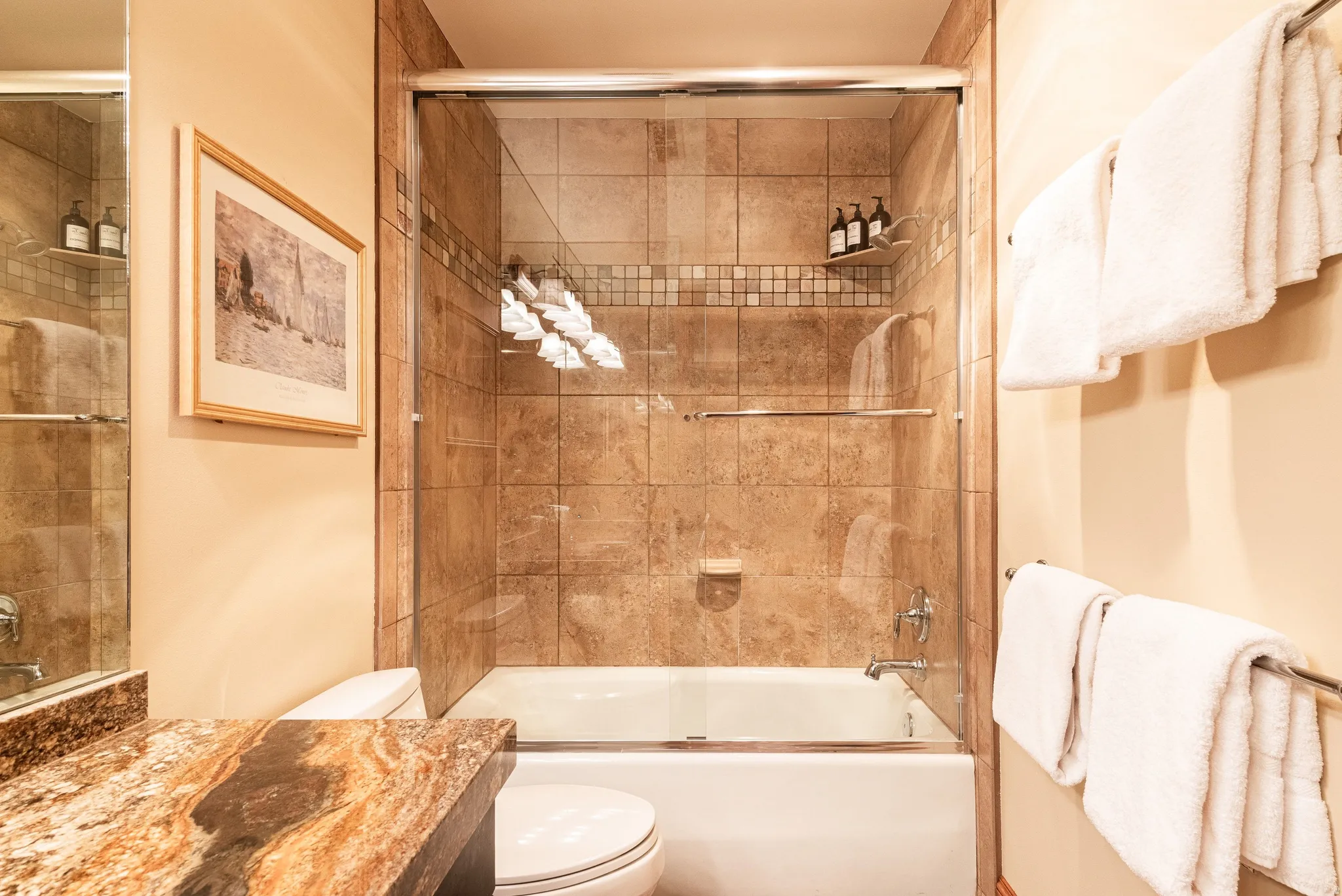 Tiled shower/tub combination with a glass enclosure