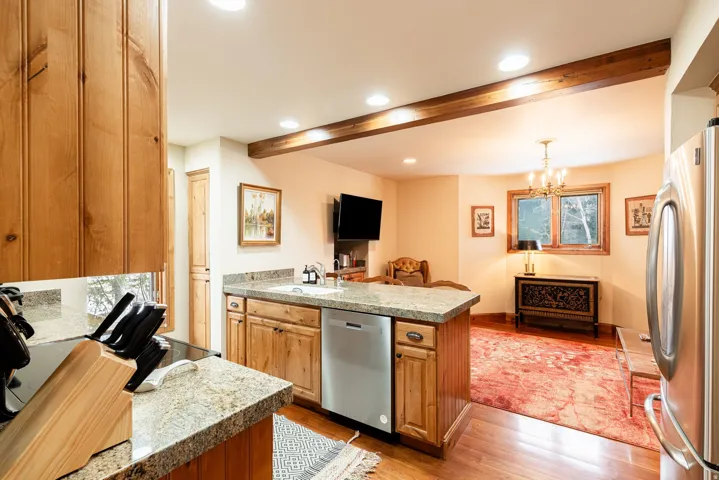 Kitchen featuring wood-finish cabinetry, granite-style countertops, and stainless steel appliances