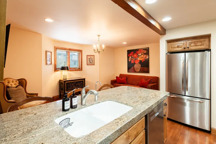 Kitchen island with a built-in sink and stone countertop