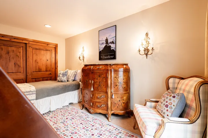 Recessed lighting illuminates wood-paneled closet doors