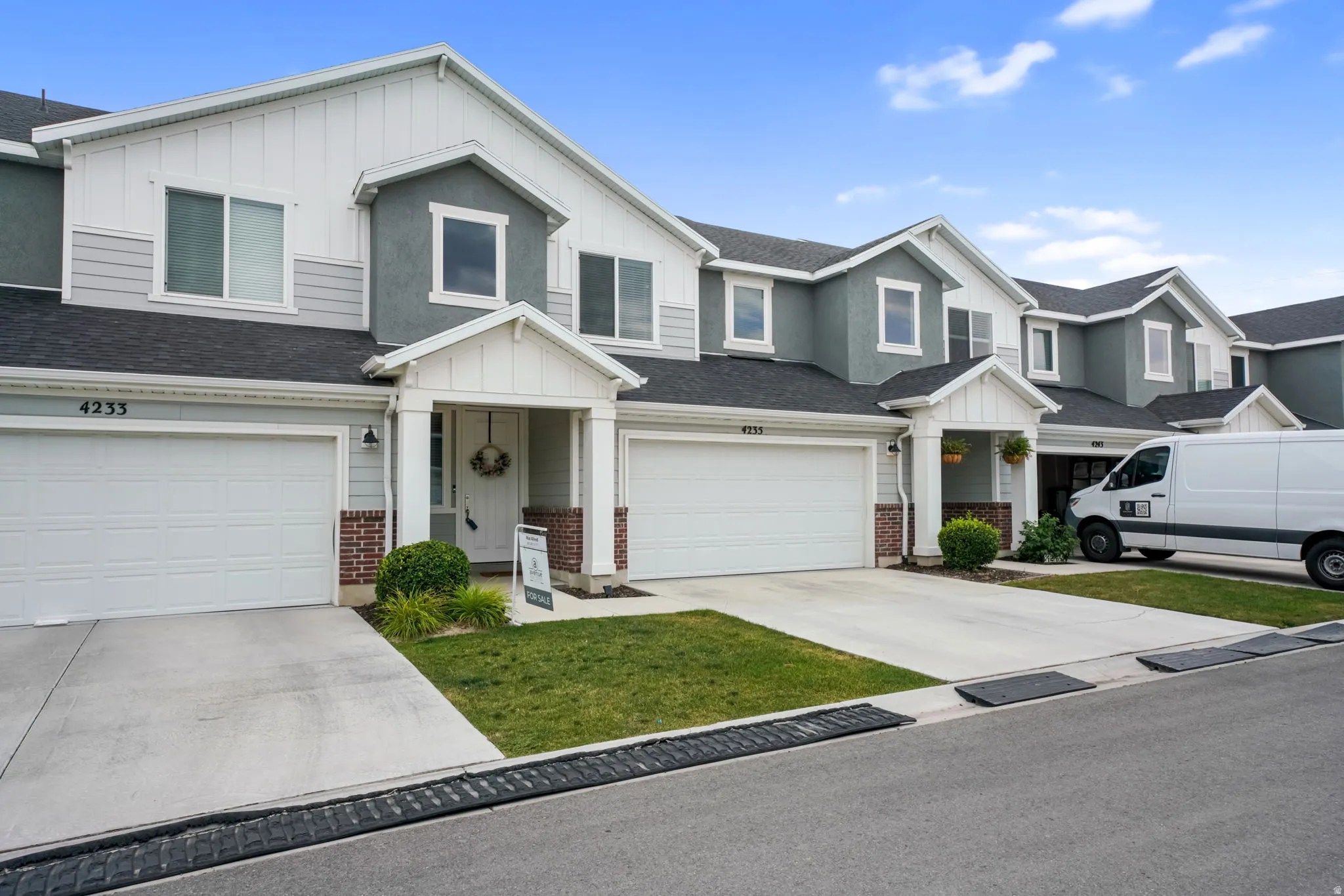 Contemporary townhome-style exterior featuring a combination of siding and stucco finishes