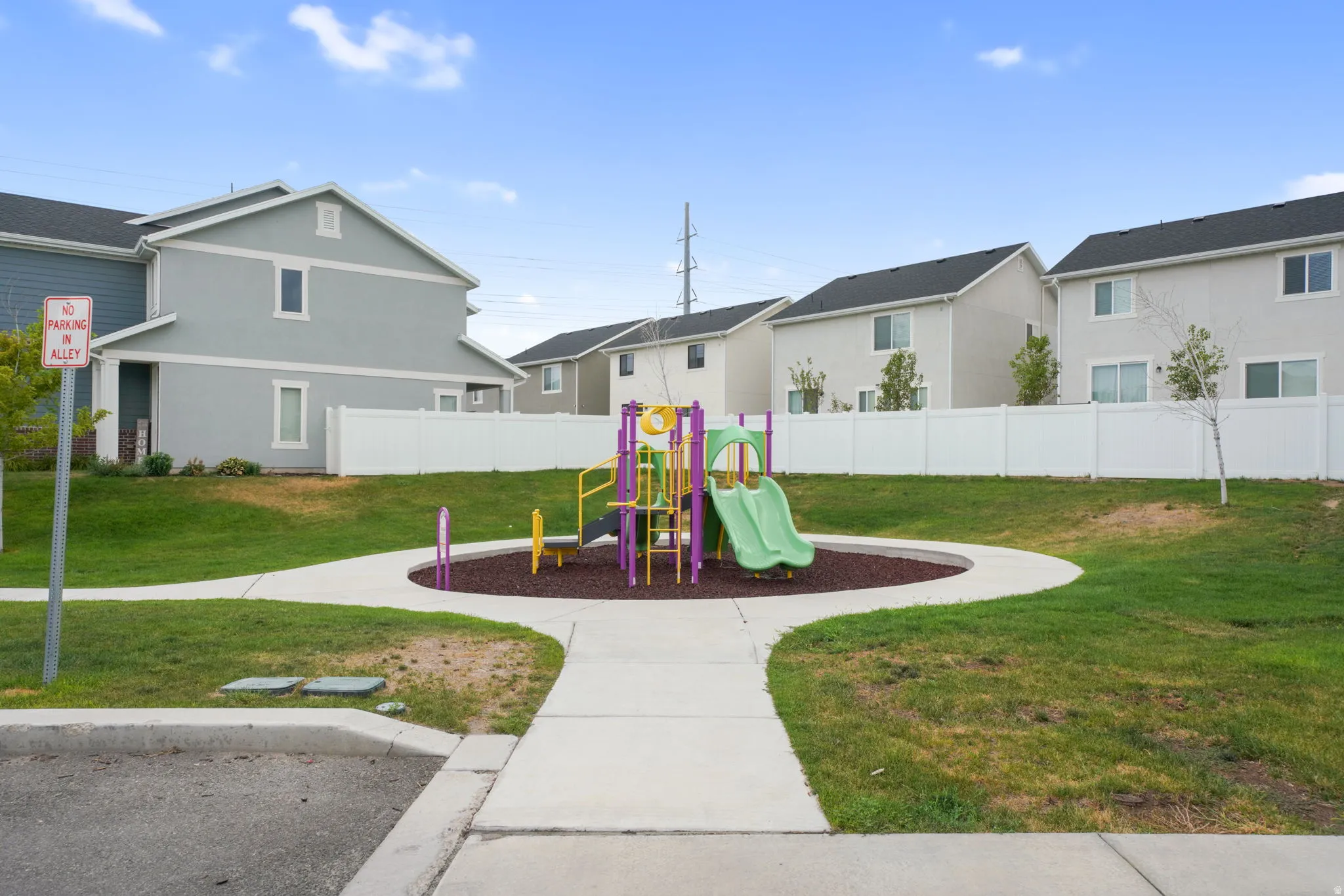 Community playground featuring a slide, climbing elements, and safety surfacing
