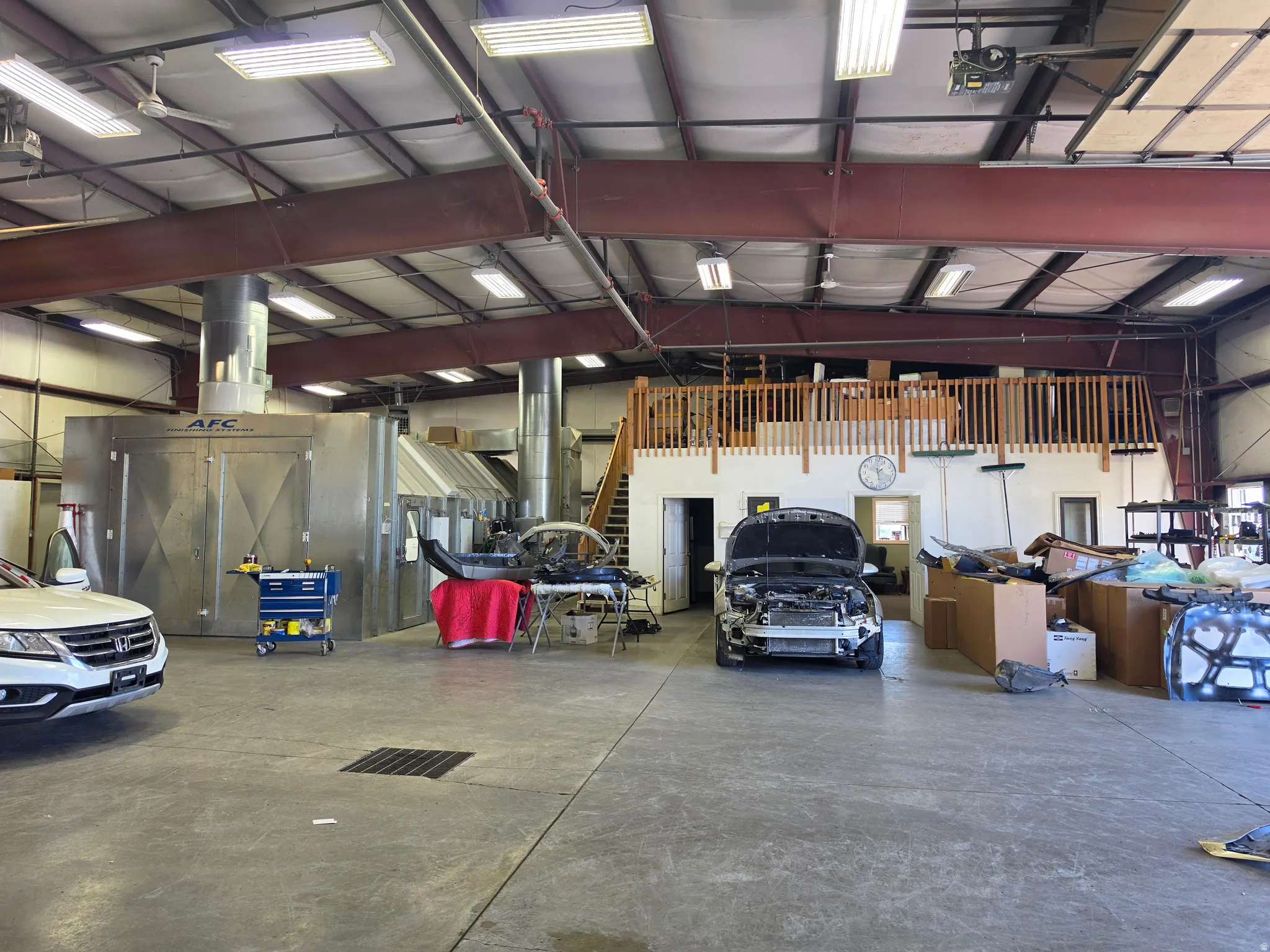 Industrial-grade concrete flooring complemented by a large, built-in spray booth system